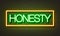 Honesty neon sign on brick wall background.