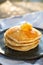 Honey being pour onto stack of pancake