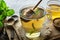 Honey being poured into a cup of mint tea.