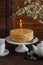 Honey cake , tea cups, teapot and flower on brown wooden table. Tea time.