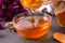 Honey dripping in glass bowl on table close up