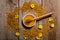 Honey in the glass bowl, pollen and yellow flowers around it