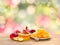 Honey in glass bowl, wooden honey dipper and honeycombs, red apples and garnet on wooden table on a blur natural background