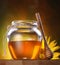 Honey in a glass jar and flower sunflower