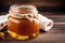 Honey in a glass jar on a wooden background. Selective focus. healthy food concept. Generative AI