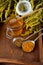 Honey in a glass jar with a wooden spoon. Still life on a wooden table with yellow flowers Goldenrod. Healthy sweet food