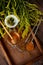 Honey in a glass jar with a wooden spoon. Still life on a wooden table with yellow flowers Goldenrod. Healthy sweet food. Close up