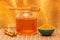 Honey in jar with dipper, honeycomb, cinnamon and