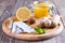 A honey jar, lemon, ginger, honey on a wooden background. Tablets and thermometer. Fighting the common cold