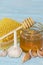 Honey and pieces of garlic on the background of honeycomb. Honey in a glass jar and honeycomb