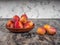 Honey plums in a clay plate on a gray table