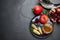 Honey, pomegranate, apples and shofar on black table, flat lay with space for text. Rosh Hashana holiday