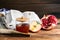 Honey, pomegranate, apples and shofar on wooden table. Rosh Hashana holiday