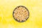 Honey puffed wheat in a bowl on a yellow background