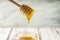 Honey stick dripping pure organic honey from bees