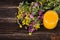 Honey, wild flowers and spoon on wooden background. Free space for your text.