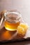 Honeycomb dipper and honey in jar on wooden background