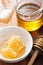 Honeycomb dipper and honey in jar on wooden background