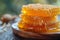 Honeycombs and honey on wooden plates