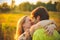 Honeymoon couple romantic in love at field and trees sunset. Newlywed happy young couple embracing enjoying nature