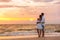 Honeymoon couple walking on sunset romantic stroll on Lover`s key beach in Florida enjoying evening light relaxing on