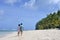 Honeymoon couple walks on a tropical pacific island beach in Rarotonga Cook Islands