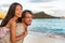 Honeymoon Hawaii beach vacation couple piggyback. Multiracial people in love on travel holidays, Waikiki beach, Honolulu, Hawaii.