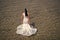 Honeymoon at sea resort. Wedding abroad. Wedding ceremony seashore. Bride white wedding dress stand in sea water. Wet