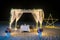 honeymoon seat with light decor on beach at night