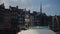 Honfleur, France - 3 May 2023. French flag flying on boat in Harbor of historic city Honfleur on background of beautiful