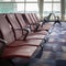 HONG KONG, CHINA - JANUARY 14, 2019: Empty airport chairs in waiting area hall at the airport with airport background