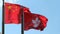 Hong Kong and People\'s Republic of China Flags flying side by side against clear blue sky on a windy day 1080p