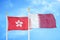 Hong Kong and Qatar two flags on flagpoles and blue cloudy sky