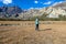 Hongde - A girl taking a selfie with Himalayas in the back