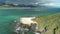 Honolulu, Hawaii, low angle view with drone camera moving backwards, beach on green island , color graded