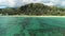 Honolulu, Hawaii, low angle view with drone camera moving backwards, clear green water with reef, color graded