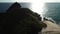 Honolulu, Hawaii, low angle view with drone camera moving forward, backlit shot of island in open waters, color graded