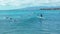 Honolulu, Hawaii, Oct 15, 2022-Drove view of surfers in Waikiki - Beginner surfer grabs wave with small catamaran in