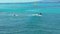 Honolulu, Hawaii, Oct 15, 2022-Drove view of surfers in Waikiki - One surfer grabs small wave while others fail to stand