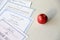 A honor roll recognition, certificate of achievement and high school diploma lies on table with red apple. Education documents