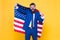 Honour and glory to my country. Happy businessman holding old glory american flag on yellow background. Bearded man in