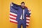 Honour and glory to my country. Happy businessman holding old glory american flag on yellow background. Bearded man in