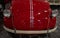 The hood of a red retro car. Lacquered, shiny antique vintage car. Close up