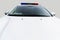 The hood of a white police car. Law enforcement vehicle with flashing beacons. Copy space. Selective focus
