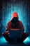 A hooded figure hacking data servers