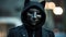 Hooded hacker with a cat mask on his face.