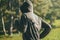 Hooded man jogging in the park in early autumn morning