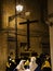 Hooded penitents during the famous Good Friday procession in Chieti (Italy) carry the cross with the writing INRI