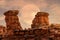 Hoodoos formation portrat in Canyonlands national Park with hazy full moon sky rising behind it