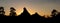 Hoodoos and trees silhouetted by sunset sky